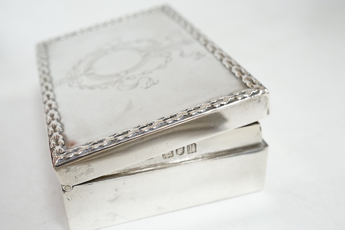 A small George V silver box and cover, possibly for snuff, by Mappin & Webb, London, 1912, 95mm, together with a later engine turned silver cigarette case, 10.6oz.